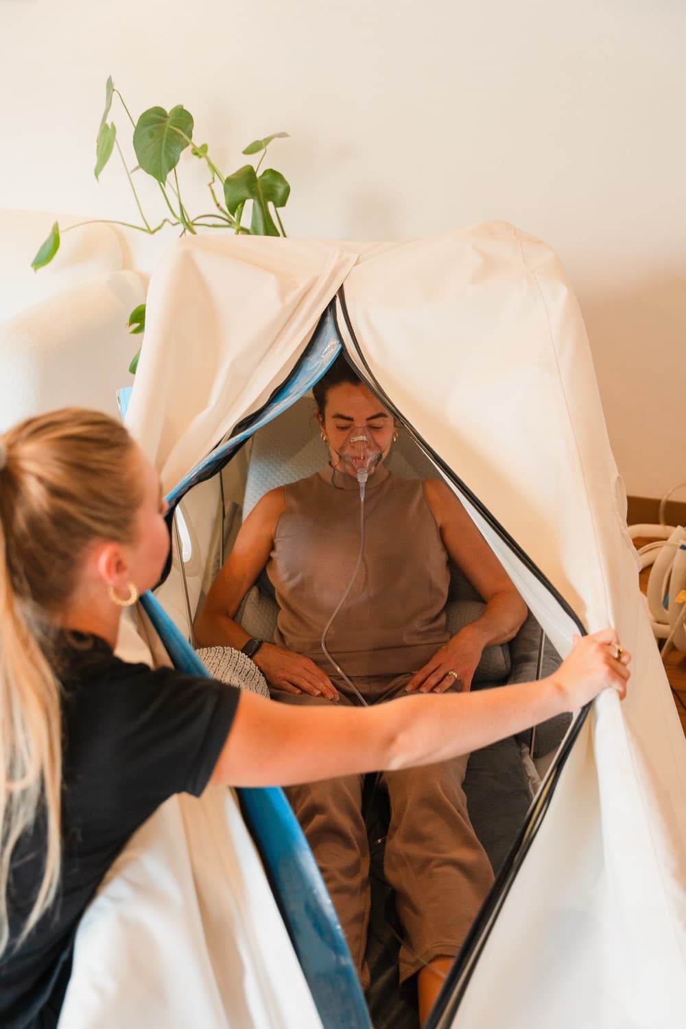 A member breathing oxygen inside a seated hyperbaric chamber