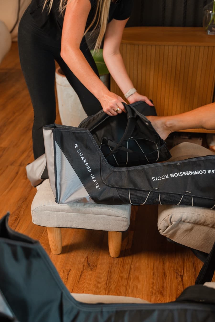 A Hype staff member fitting a member with air-compression boots