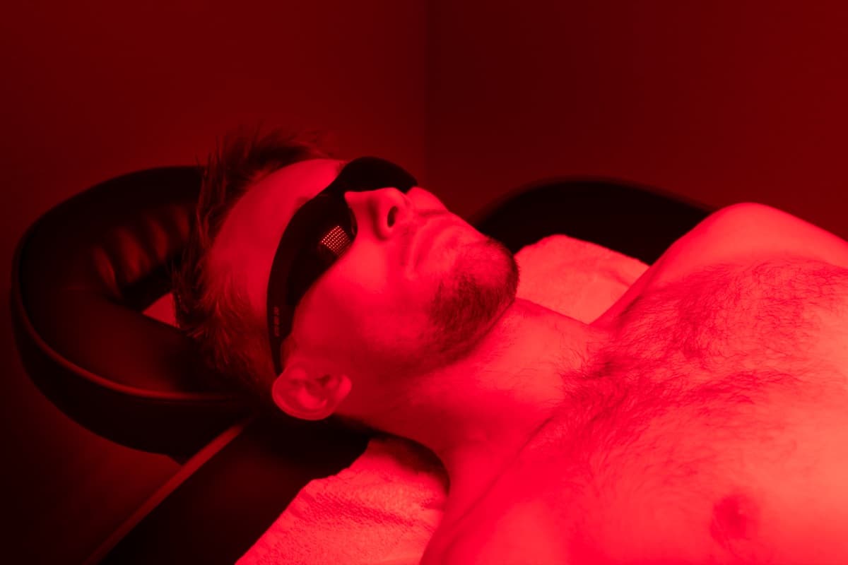 A member relaxing under red light therapy panels