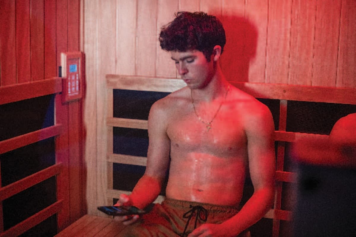 A young athlete in the infrared sauna